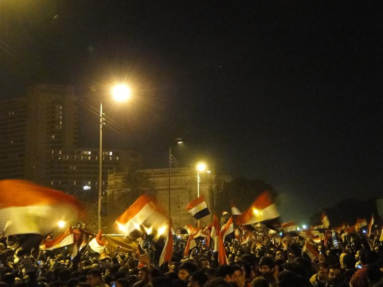 Egyptians in Cairo wave the national flag after the departure of President Moubarak in February. (Credit: Flickr user RamyRaoof/CC)