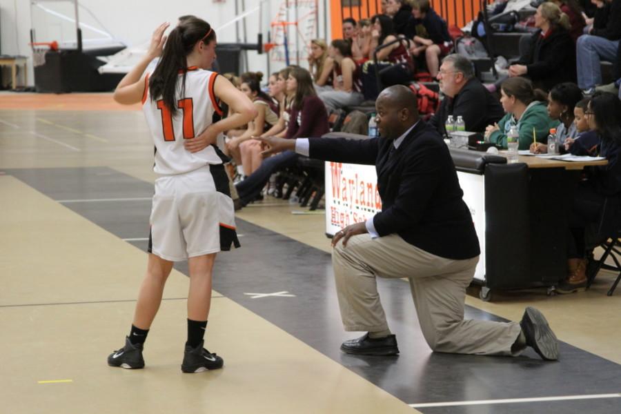 Girls basketball Coach Brewster Cupid directs one of his players.(Credit: Martin Narciso)