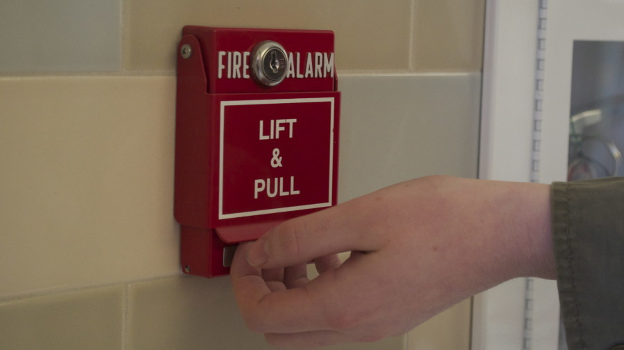 Above is a photo illustration of a student pulling the fire alarm. This is one of the outrageous methods of cheating WSPNs Whitney and Allison talk about.