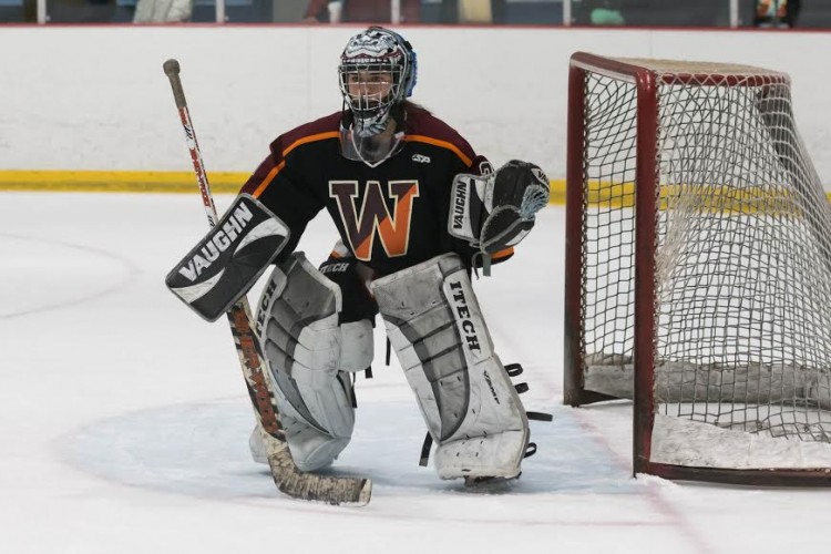 Above is sophomore Lilly Lin playing hockey for Wayland. Lin is a three-season goalie and plays soccer, hockey and lacrosse for WHS. I love the way sports bring so many people together, Lin said.