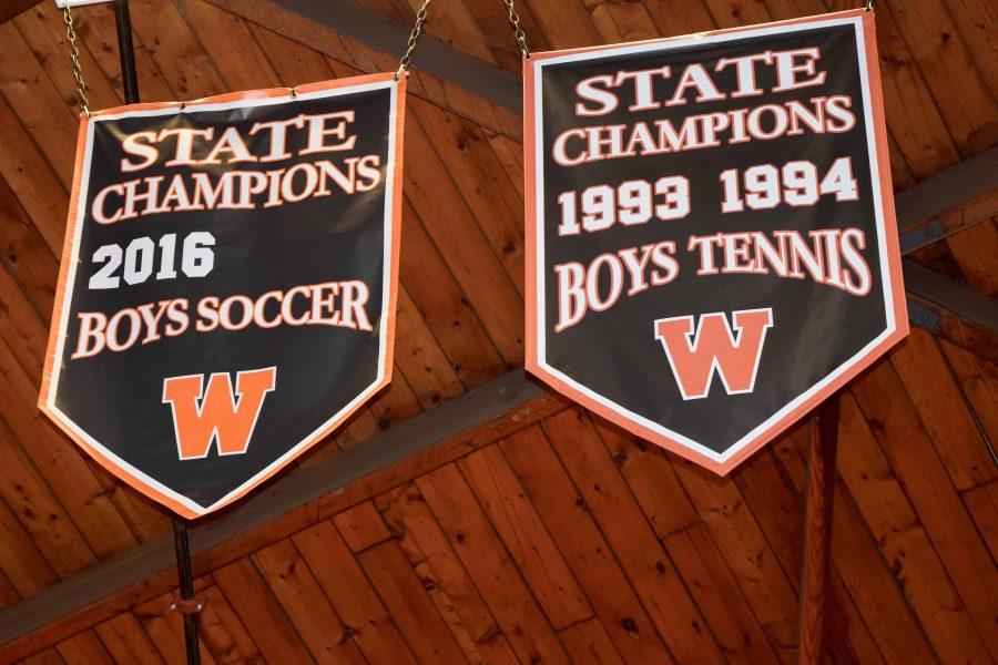 Pictured above are the State Championship banners hanging in the field house. Andrew D’Amico writes “If you’re not training for the majority of the year to become the best at one sport, someone else is, and chances are, you’re going to lose to them.”