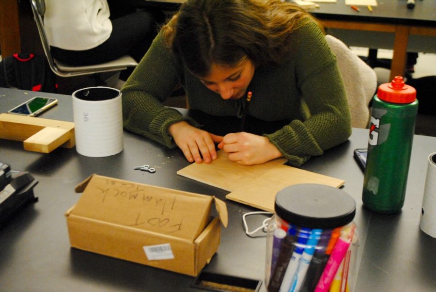 Pictured above is a student building a birdhouse at History Department Head Kevin Delaneys woodworking workshop. Delaney hosted the workshop in the makerspace on Friday as a part of WHS annual winter week. If this [workshop] exposes the makerspace a little bit and gets one or two kids thinking about it, then [I believe it has] succeeded, Delaney said.