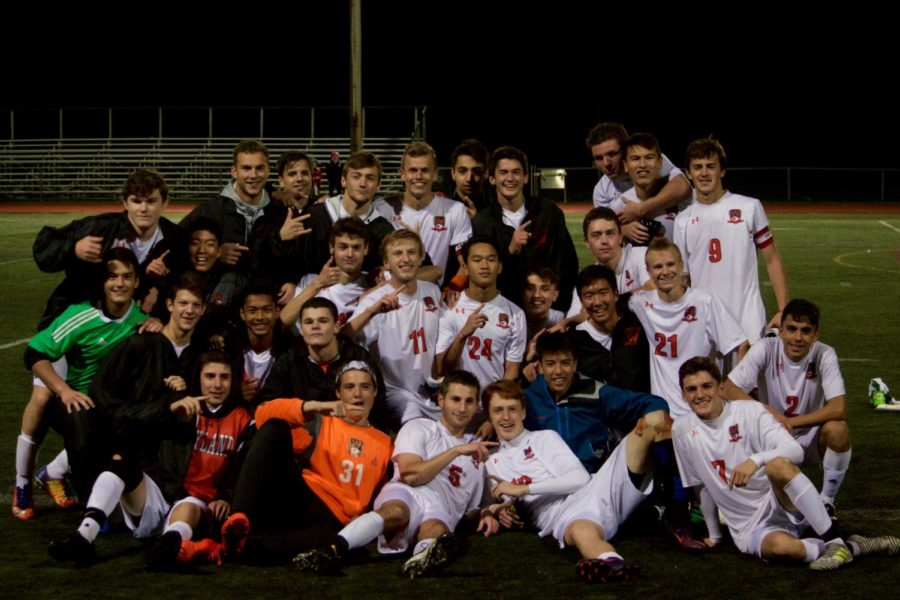 The boys' varsity soccer team poses for a photo after their win.