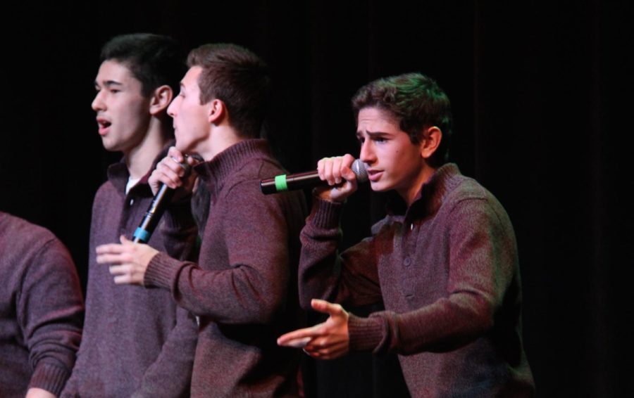 Pictured above is senior Logan Dawson singing at a cappella's 2016's Winter Week performance.  He is one of this year's directors for the Madrigals.  