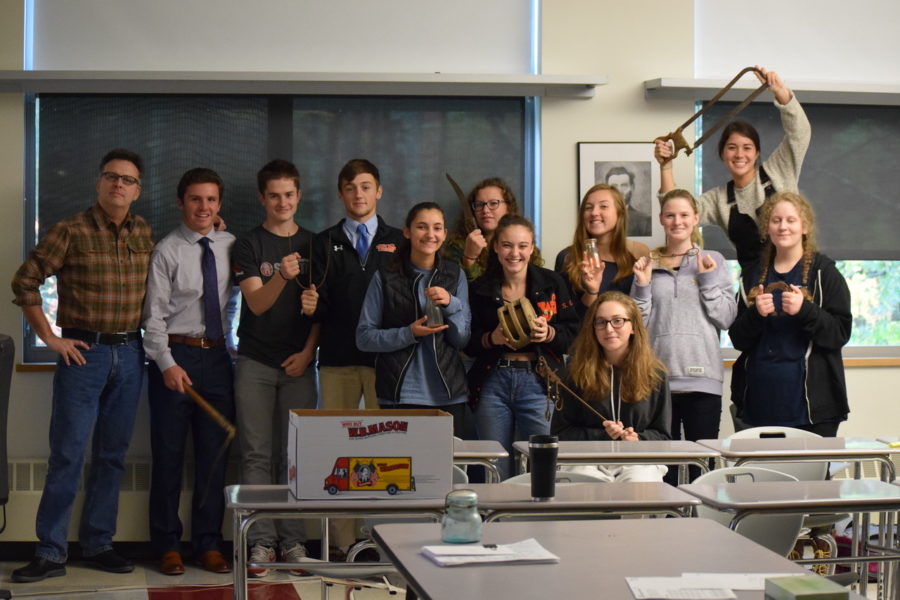 Pictured above is History department head Kevin Delaney and his class of 11 with tools from the past.