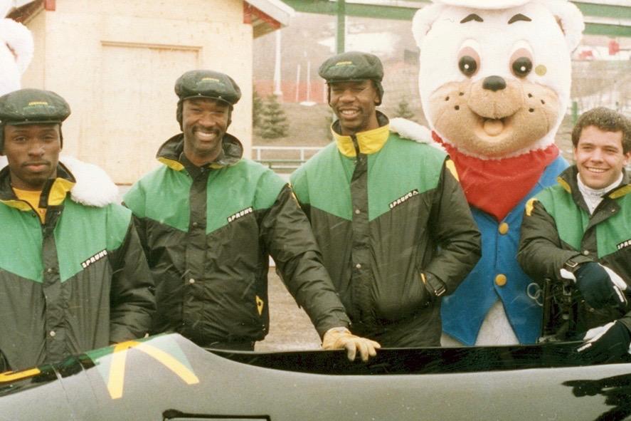 Pictured above is the 1988 Jamaican Bobsleigh team with coach American Patrick Brown at the Calgary Olympics. Brown and Jamaican athlete Devon Harris spoke with WSPN about their Olympic journey and commented on the alleged racial insensitivity in the film Cool Runnings that was based on their story.