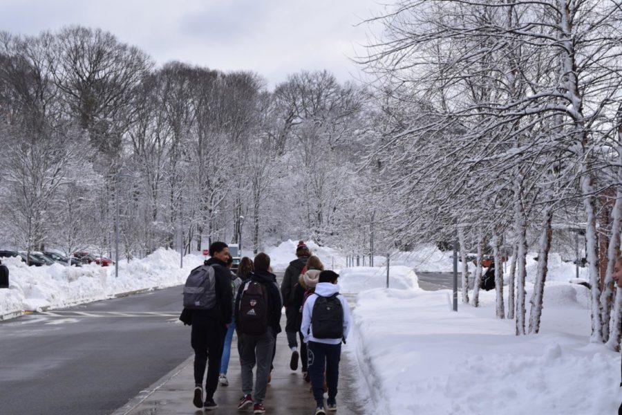 Students walk in the snow. WPS Superintendent recently announced a two-hour delay to school start times tomorrow, with the potential for a full cancellation by 5:15 a.m. on Tuesday morning.