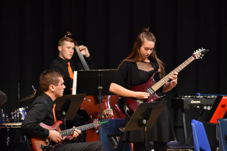 Pictured above is junior Sophia Schroeder playing at a WHS jazz band concert. [The guitar] is really versatile, and I feel like you can play pretty much anything if you work at it, Schroeder said.