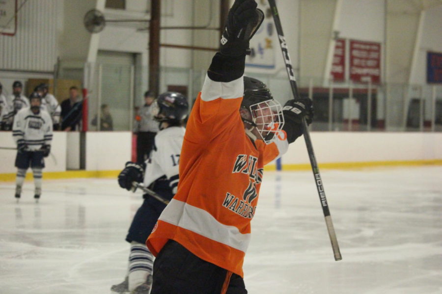 Lyons looks to the fans while celebrating a goal. 
