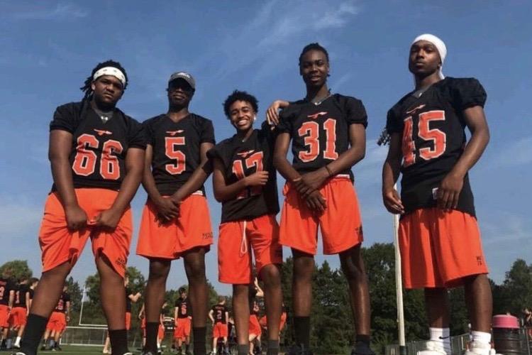 Bernier (center) with his football teammates.