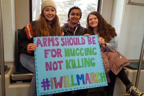 Sophomores Zoe Hughes, Kyra Singh and Grace Rogers hold up a sign.