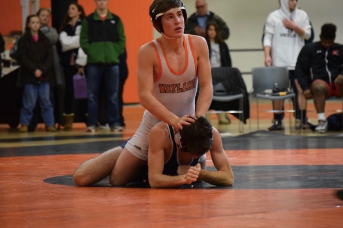 Senior Ramazan Attasuav pins down his opponent during a match.