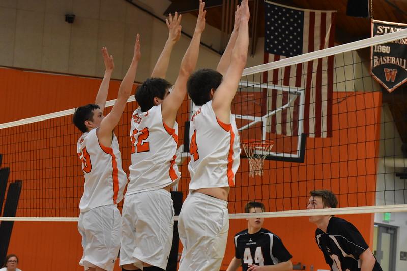 Players on the boys varsity volleyball team rise to block a hit against Lincoln-Sudbury on  April 25.