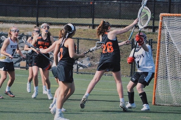 Senior Lily Tardif shoots at the goal during an away game against Weston. Tardif has played lacrosse from a young age and will be playing Division 1 NCAA Lacrosse next year. “I would always practice on the wall and shoot pretty much every single day because I was a crazy freshman who was obsessed with lacrosse, Tardif said.