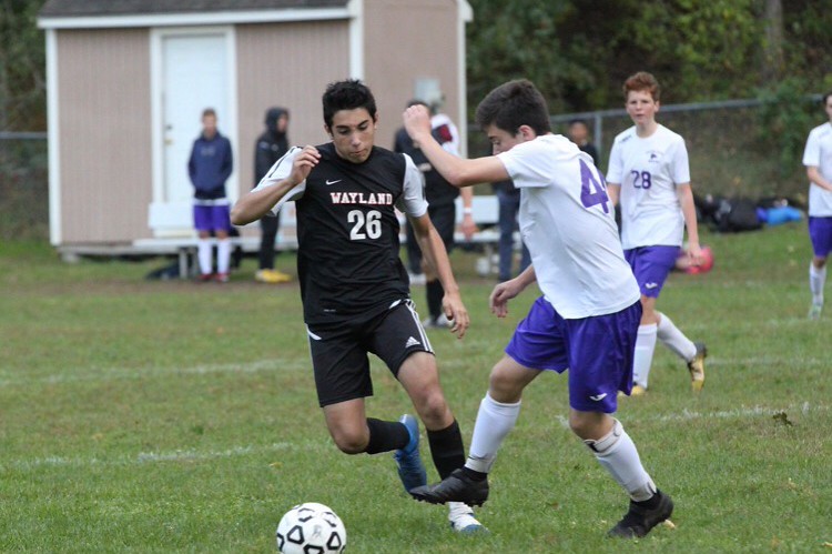 Zeke Betancourt takes the ball upfield in a JV soccer game. Betancourt enjoys the laid back environment of JV. On other varsity sports, you can’t talk and goof around as much during practice, Betancourt said.