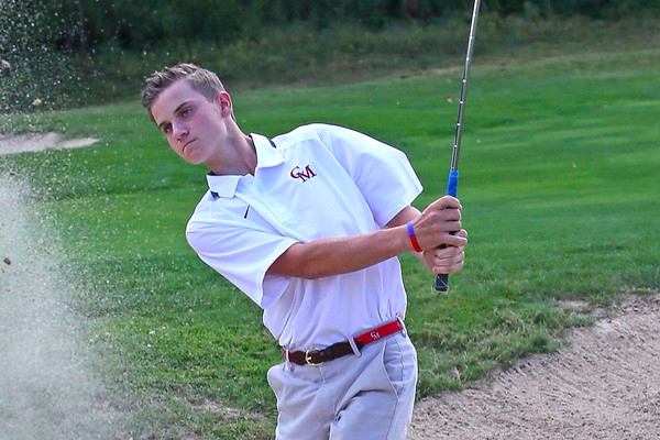 Junior Liam Gill hits a shot out of the bunker during the Catholic Conference Championship in 2017. Last year, Gill won the conference as a freshman at Catholic Memorial. Golf, in my opinion, is like no other experience in life, Gill said.