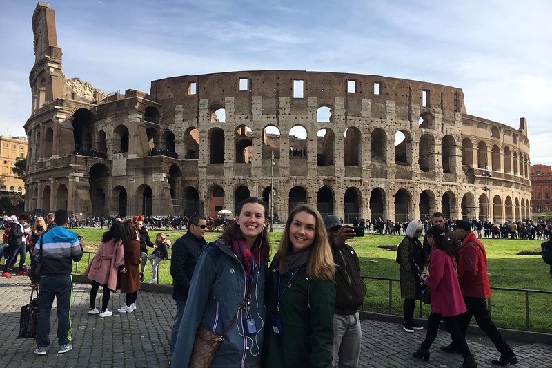 Pitcairn with a friend outside of the Colosseum in Rome.  