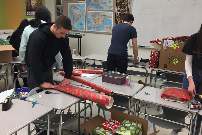 Students package the donated gifts that will be going to children at the Yawkey Center daycare on Dec. 18. “I receive a lot of things during the holidays, so it feels good to give back,” junior Alexandra Kennedy said.