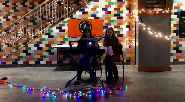 Senior Lizzy Francis and junior Zoe Hughes sing a duet at last year’s coffee house. The event is organized by the Amnesty International club and features a night of performances to fundraise for the club’s parent foundation. “It’s so important to actually know what’s going on and try to get involved in any way,” senior president Lindsay Adelman said.