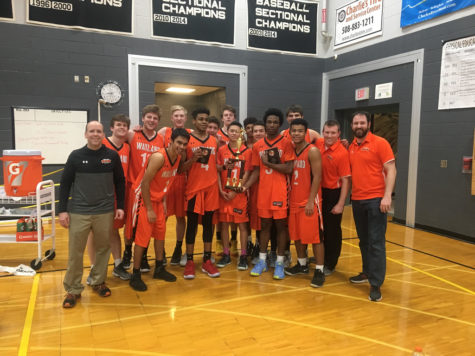 Boys basketball brings home holiday tournament trophy