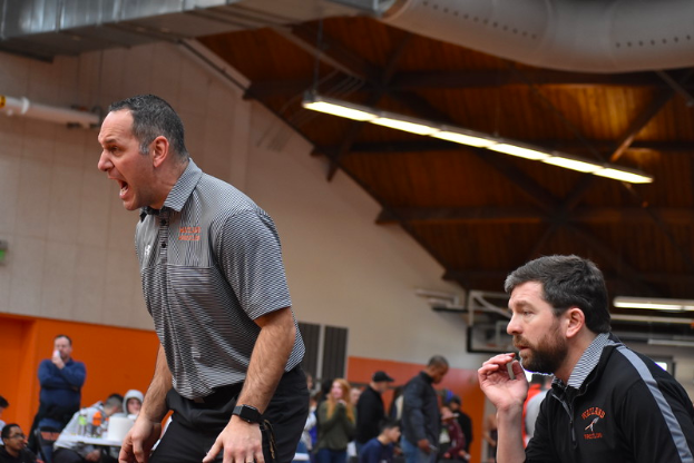 Coaches Scott Parseghian (left) and Sean Chase (right) yell to Junior Cameron Jones at sectionals on Saturday Feb. 9. “I mean, you do it to win, you do it for the relationships you build with the kids, but when you win it just makes it that much better.” Parseghian said.