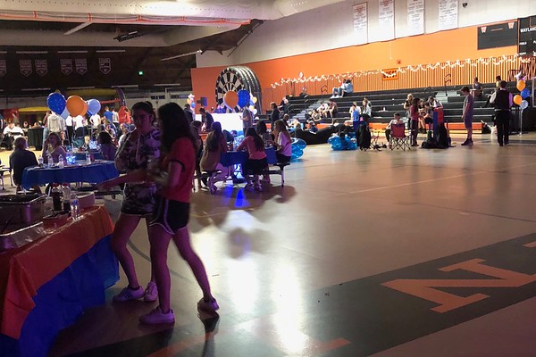 Students stand by a table waiting for their food at late night 2018 . This year, Wayland School Public Organization and Wayland Cares plan to implement new rules to make late night a more safe environment. “There will be stricter rules during late night, meaning if you are ever caught with anything you will be sent home from whatever event you are attending,” Class of 2020 president Ciara Murphy said.