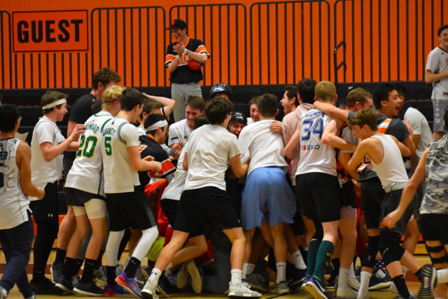 Students run onto the court and form a mosh pit after freshmen team Daj Mabal upsets a team of sophomore boys, OM.