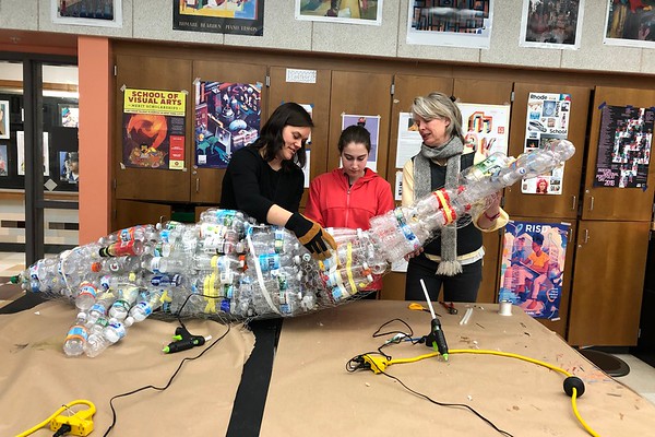 Art Teacher Veronica Latimer, junior Green Team member Rachel Tolmach, and English teacher Sara Snow construct the plastic whale Myrtle by using bottles found in recycling containers around the school.