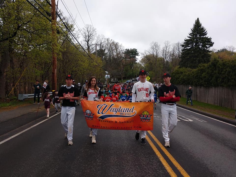 Athletes+from+both+the+high+school+softball+and+baseball+teams+volunteered+to+help+lead+the+group+of+Little+Leaguers+march+from+Cochituate+Field+to+the+middle+school.+When+parents+line+the+parade+instead+of+watching%2C+I+think+that%E2%80%99s+the+best+part%2C+especially+%5Bfor%5D+the+little+kids+because+the+really+little+kids+get+super+excited+to+be+part+of+a+parade%2C+softball+coach+Erin+Ryan+said.