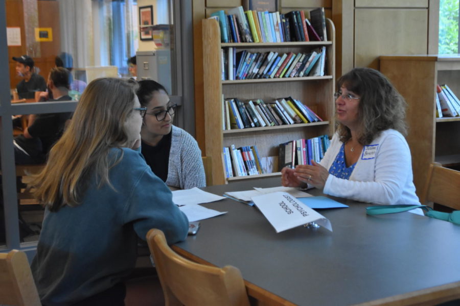 Juniors Sarina Patel and Molly ODriscoll speak with Wayland Middle School counselor Suzanne Bernstein.  
