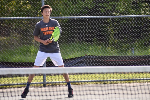 Boys varsity tennis player sophomore Noah Lee stands ready in his singles match against Bedford. “We really cherish that playoff opportunity, especially for the young guys," Lee said. The team is set to play in the North semifinals next.