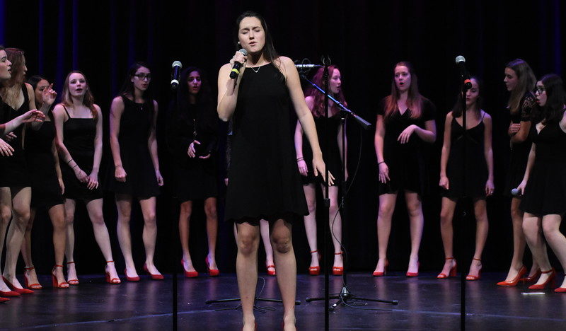 Senior Arden Knapp sings at an a cappella concert. She is one of the directors of the Muses, the all-girls group.