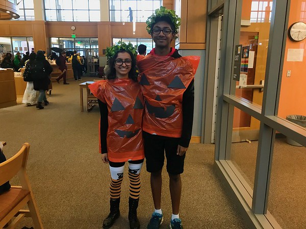 Seniors Kyra Singh and Dravin Nagalingam dress as pumpkins and smile for a photo. I think its fun that were finally to this stage of high school, where we can dress up, Nagalingam said.