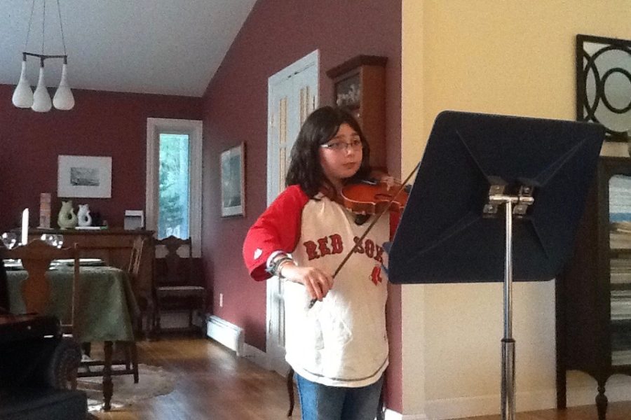 Young Sam Baron practices the viola. “My favorite part about playing the viola is that it is different, Baron said.