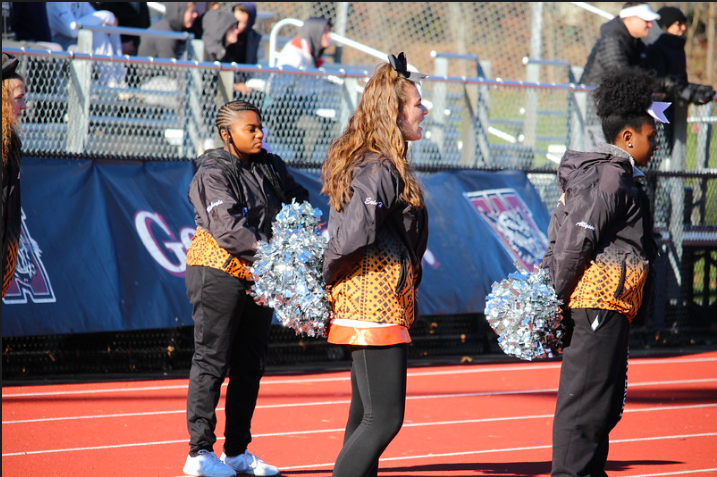 WHS cheerleaders watch intently as the football team plays against Marblehead. The cheerleading team recently placed third in the Division 3 DCL Competition. This years team is more engaged in [the football team] and whats happening with the team, senior cheerleader Michayla Mathis said. We really get excited when they win but I feel like our enthusiasm is really high this year. 
 