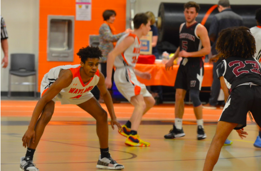 Junior Jabari Nurse gets into his defensive stance as he prepares to pressure the ball. Jabari recently left Wayland to go private for basketball, along with senior Jaden Brewington. "[Moving] is a very long process, and it's definitely a commitment," an anonymous Wayland boys basketball player said. "But it’s worth it in the end."