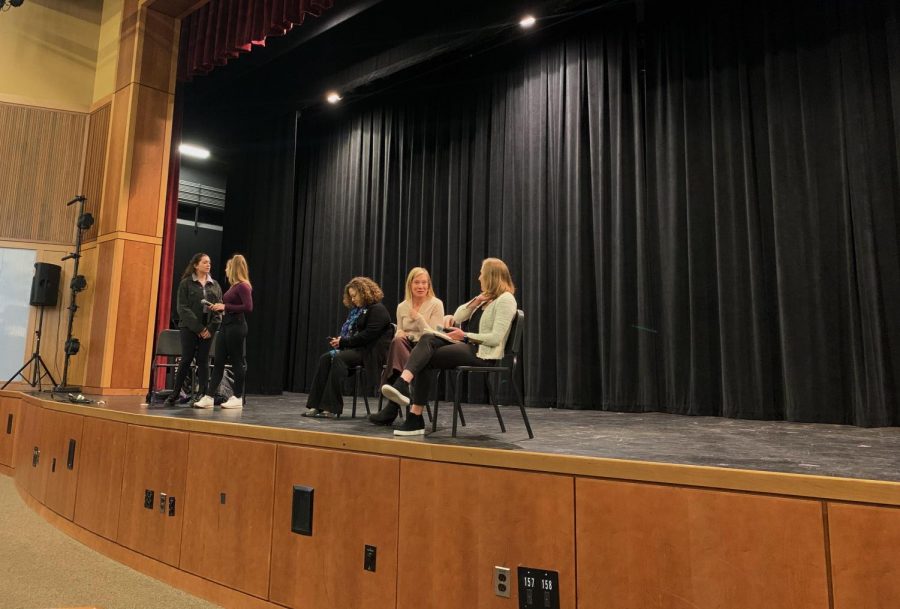 Panel speakers Becca Rausch, Angela Ferrari, and Foster Newcome prepare to speak about their life as working women. 