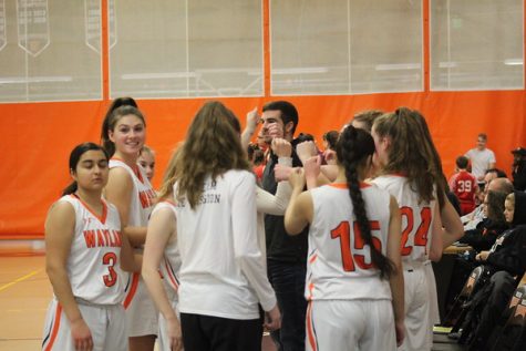 As Coach Rukstalis calls for a timeout in the first half, the girls huddle together before they enter back into the game.