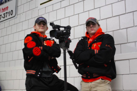 Boys varsity hockey team managers seniors Timmy Goodfellow and Brett Morris take on many jobs, one of them being filming games.
