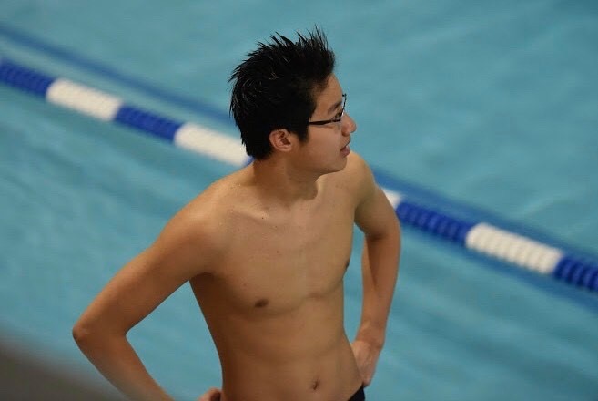 Sophomore Jason Shu watches an ongoing meet before it’s his turn to race.