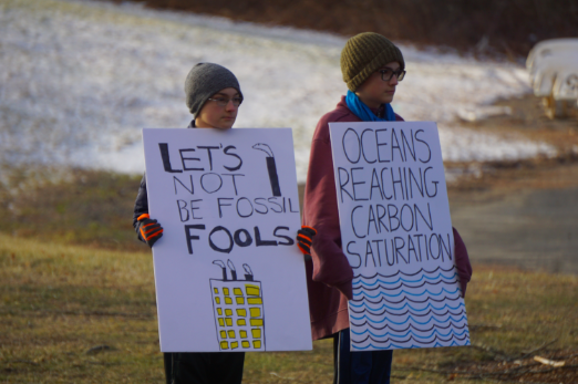 Sixth-grade twins, Marley and Julian Eggers, hold signs at one of their daily climate strikes in front of WMS. The brothers began protesting in September as a way to call out inaction by adults on the climate crisis. “There’s a lot of harsh realities,” M. Eggers said. “When we look at adults, it’s a little bit hard not to notice that they’re not doing enough, or in general, not doing anything. They should be tackling this issue.”