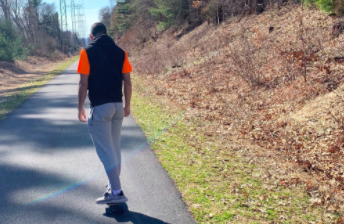 Senior Marcos Pereira penny-boards on the Wayland Rail Trail. “I decide to go on rail trails because they’re typically long and good to skate on so it’s a nice way to kill time throughout these long, boring days,” Pereira said. 