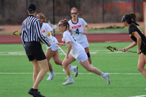 WHS graduate Kate Balicki races past her defender and down the field. Balicki is just one of many athletes whose season was cut short by COVID-19.