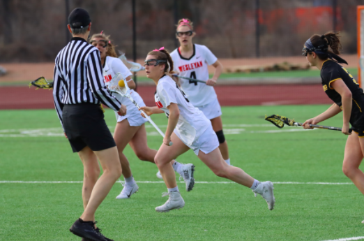 WHS graduate Kate Balicki races past her defender and down the field. Balicki is just one of many athletes whose season was cut short by COVID-19. All spring athletes have every right to be upset about this big change, but rather than dwelling on this time off, I think that its best to see it in a positive light and taking it as an opportunity to improve, Balicki said.