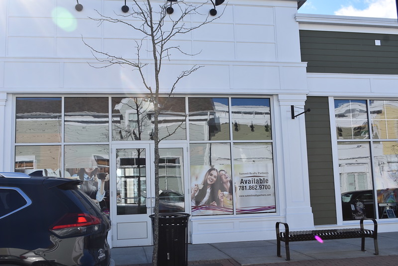 The Wayland town center is still looking for businesses to fill the vacant lots. Signs with information about leasing opportunities in order to try and fill empty spaces have been hung in the windows.