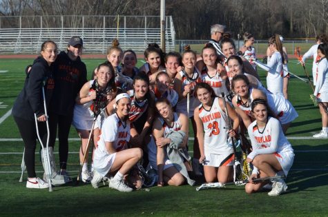 Members of the 2019 varsity girls lacrosse team get together after their game. This year, all spring senior athletes were denied their final spring season. “Volleyball is really the unfinished chapter of my high school athletic career,” said Davies. “It’s just sad that I will never get to leave the impression that I would have liked to in volleyball.”