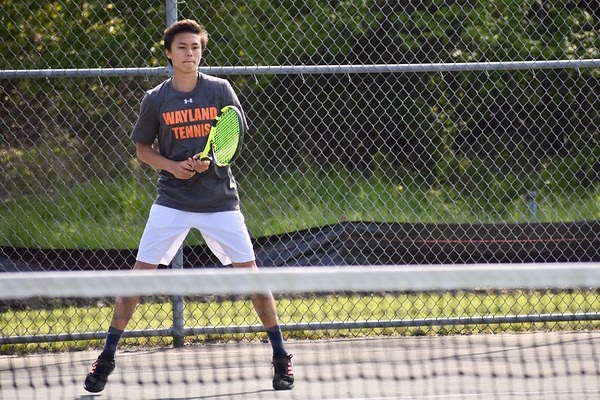 Boys varsity Junior tennis player Noah Lee stands ready in a singles match during last years spring season. Corona virus has cancelled all spring sports from continuing the 2020 season. Many athletes continue to train for their sports, even though the season was cancelled. “[I am] doing daily exercise, running, [and] practicing lacrosse with a bounceback,” freshman Marion Hess said. 
