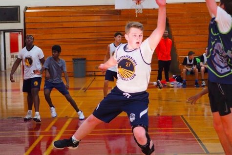 Sophomore James Danforth, a shooting guard for the Boston Warriors, contesting a shot not long after the game began. Athletes, like Danforth, saw their club season get canceled right as it began to kick off.