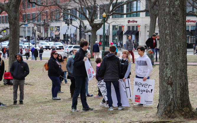 The lockdown protests resemble the 2018 March for our Lives protests, in which protestors like these in Rhode Island held signs in public areas.