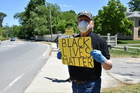 Malcolm Astley holds a 'Black Lives Matters' sign in front of the First Parish Wayland.